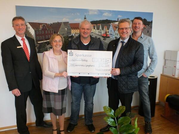 F&uuml;nf Personen bei einer Spenden&uuml;bergabe.