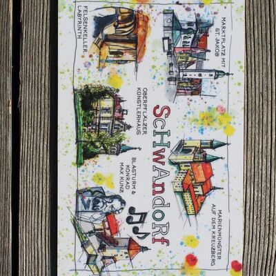 Bild vergrößern: Das Frühstücksbrettchen mit verschiedenen Motiven aus Schwandorf: Blasturm, Konrad Max Kunz, Marienmünster auf dem Kreuzberg, Marktplatz mit St. Jakob, Oberpfälzer Künstlerhaus