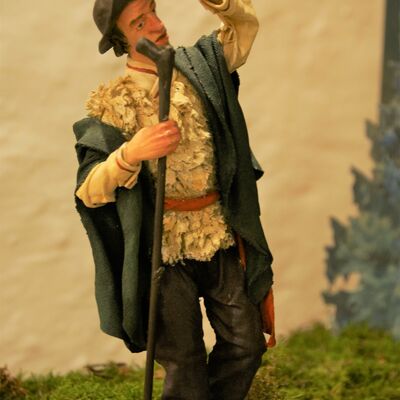 Bild vergrößern: Eine Figur aus der Krippe "Hirtenverkündigung". Ein Mann mit einem Hirtenstock und flaternden Kleidern.