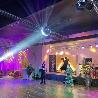 Foto von Johannes Lohrer und Anna Theuerl tanzen auf der Tanzfläche in der Tanzschule Theuerl, es spielt eine Lichtshow.