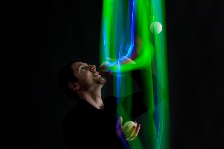 Bild vergrößern: Ein Knstler macht Lichtimpulse in der Luft