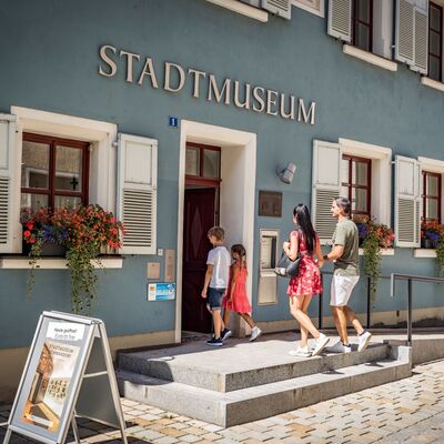 Eine Familie geht in das Stadtmuseum