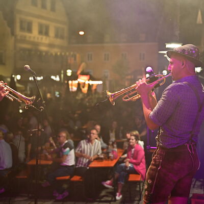 Bild vergrößern: Schwandorfer Bürgerfest 2025. Zwei Bläser der Band "Blechzipfl" auf der Bühne am Marktplatz. Dahinter ist das Publikum zu sehen.