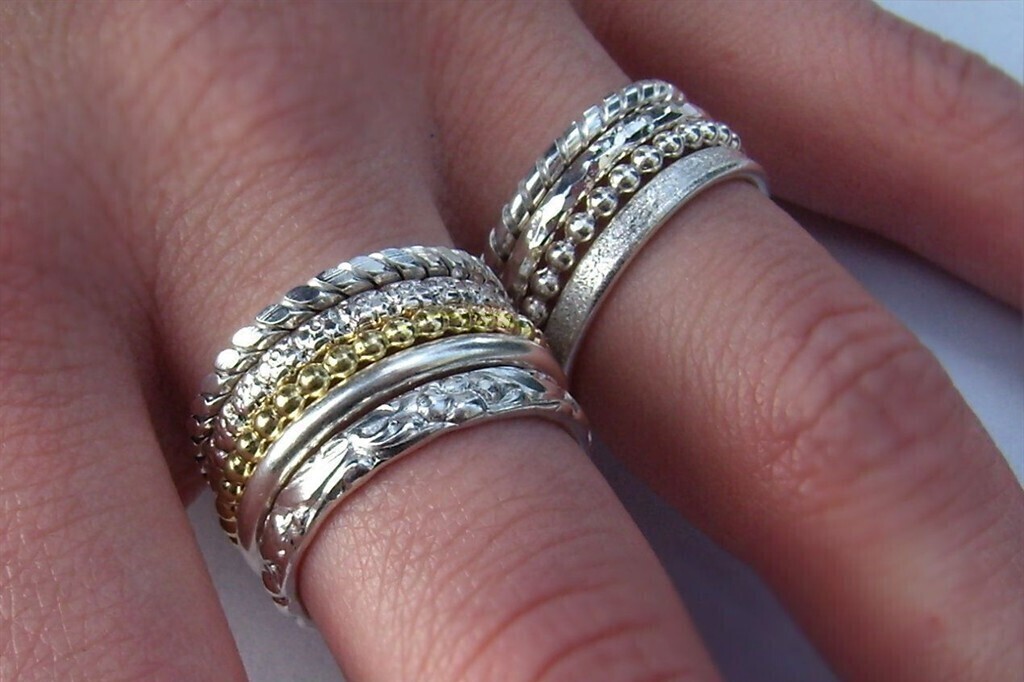 Bild vergr&ouml;&szlig;ern: Man sieht eine Hand mit vielen Ringen an einem Finger